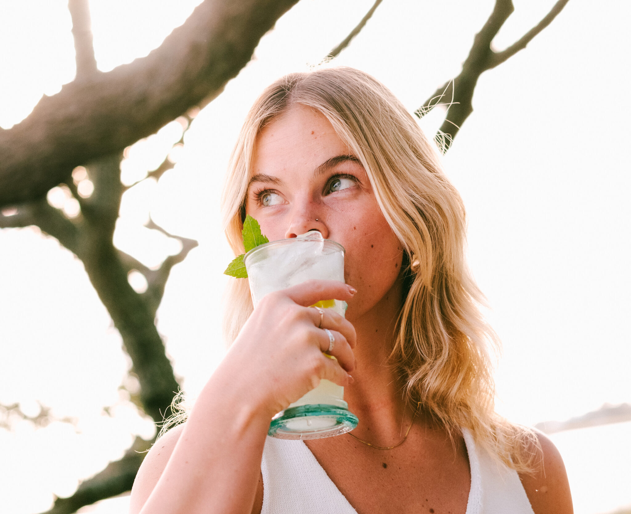 young girl sipping non alcoholic cocktail drinks outside